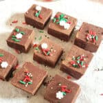 Pinterest image with text overlay for holiday chocolate fudge garnished with sprinkles.