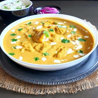 Delicious paneer makhani which is popular Indian curry is served with rice and pickled onions for comfort food dinner.