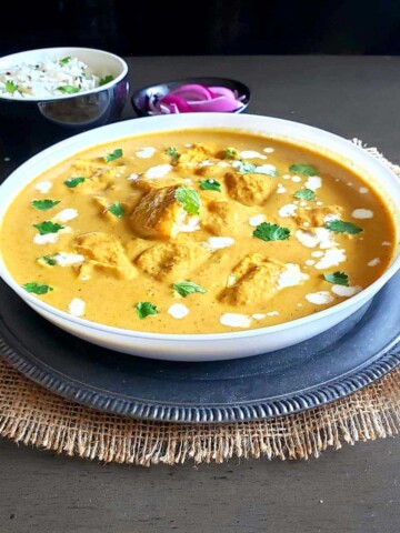 Delicious paneer makhani which is popular Indian curry is served with rice and pickled onions for comfort food dinner.