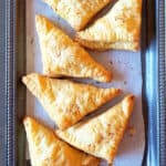 Six dessert puff pastries served on the platter.