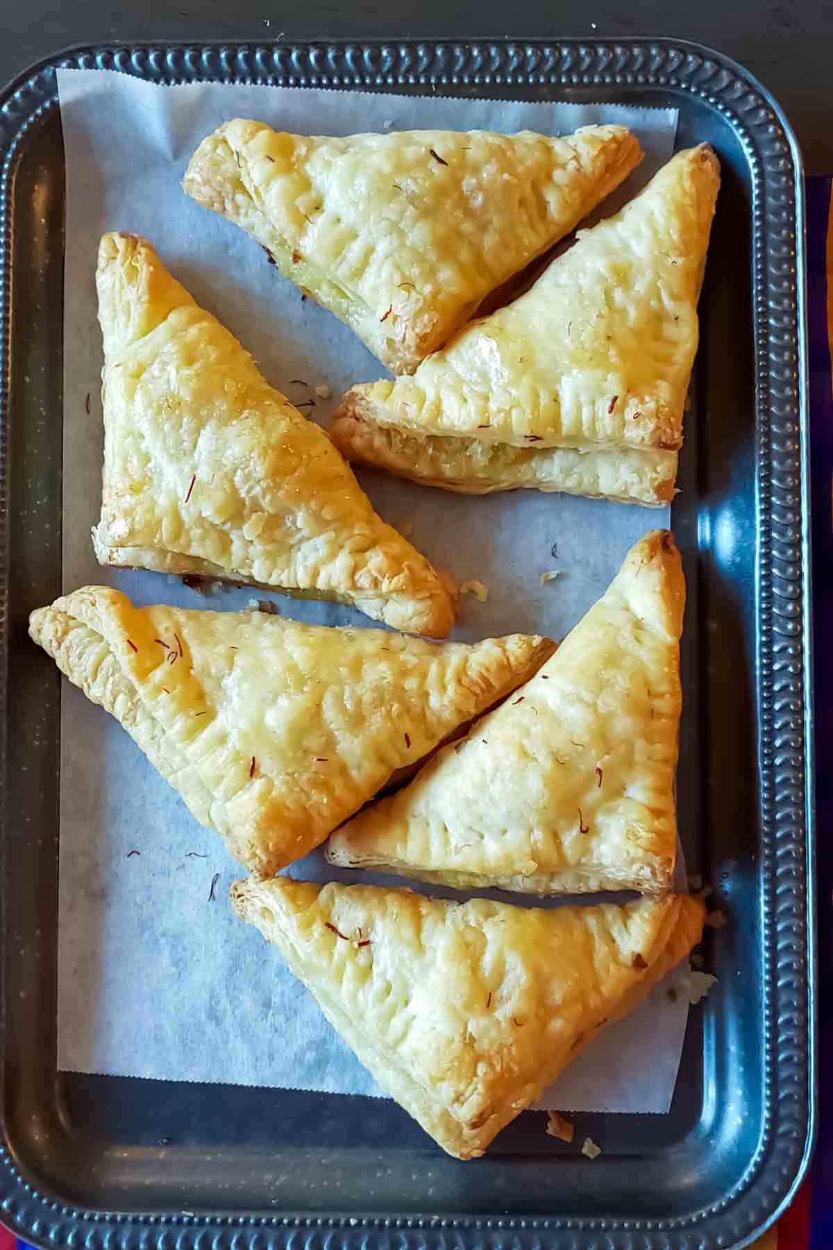 Triangle-shaped coconut puff pastry dessert with a sweet coconut filling.