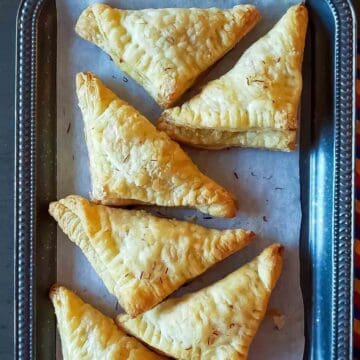 Sweet coconut pastry triangles made with puff pastry and condensed milk and baked in air fryer.