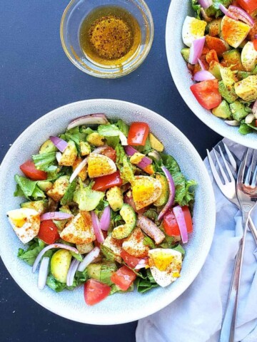 Close up image showing all the colorful veggies and hard boiled eggs used in this making this scrumptious salad.