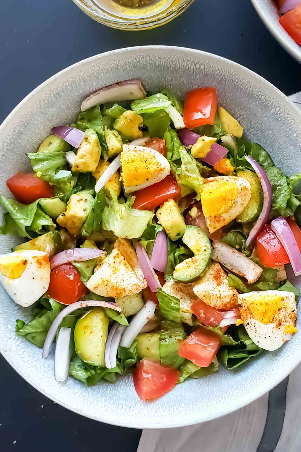 Close up of all healthy ingredients and seasoning used in making salad recipe with avocadoes and eggs. 