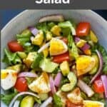 Avocado Egg salad with veggies and dressing served in a bowl. This grain free salad is low carb and gluten free.
