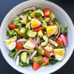 Avocado egg salad recipe served in a bowl with homemade dressing.
