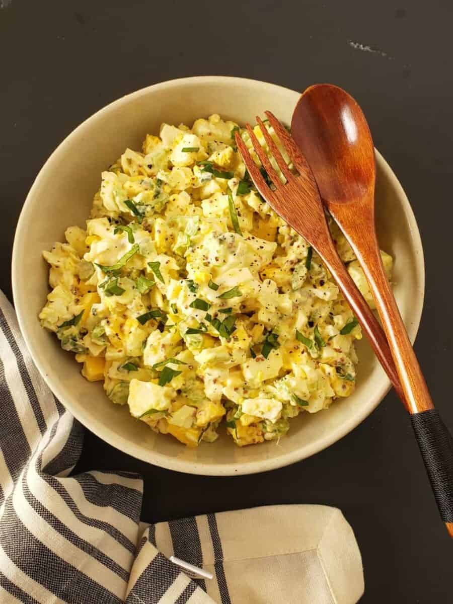 A bowl filled with creamy egg salad .