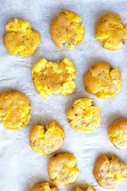 Golden baby potatoes smashed to make delicious appetizer.