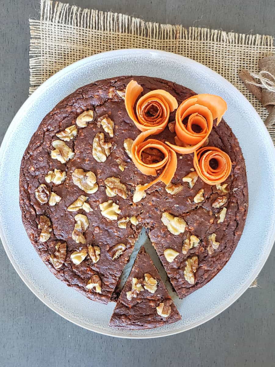 Carrot cake with dates sliced and served on the dessert plate.