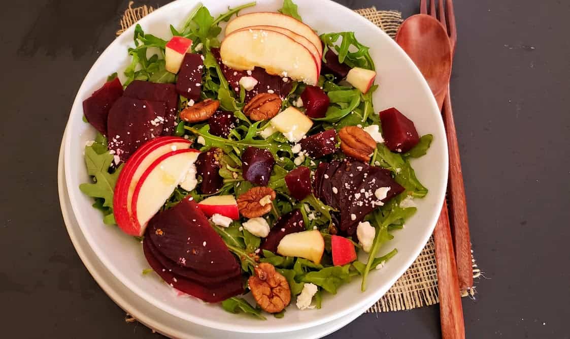 Colorful rocket and beetroot salad with other garnishes.