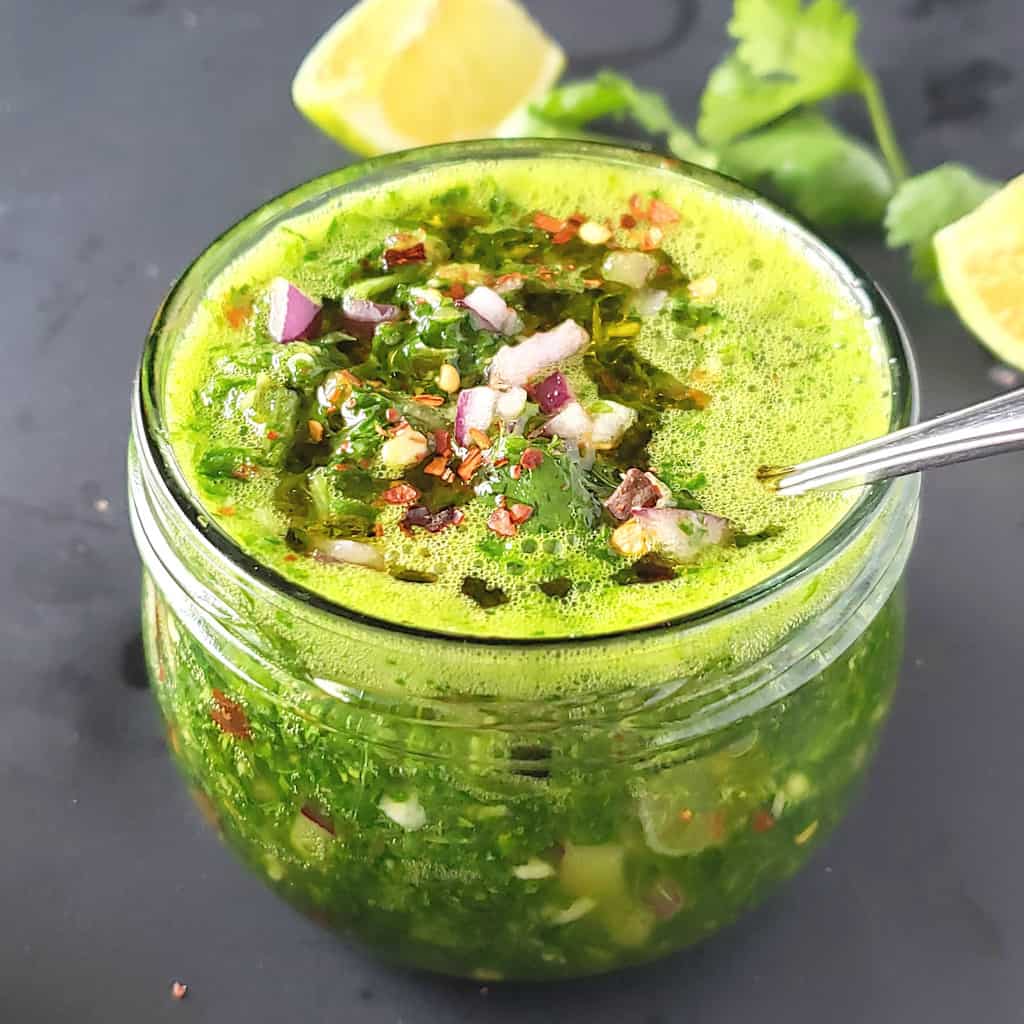 https://profusioncurry.com/wp-content/uploads/2022/05/Cilantro-chimichurri-sauce-with-red-onion-and-red-pepper-on-top.jpg
