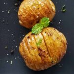 Crispy roasted hasselback potatoes served for dinner.