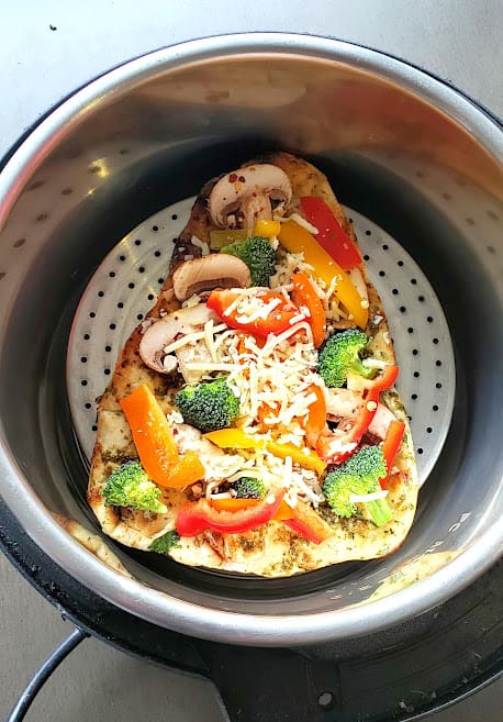 Pesto pizza on naan bread made in Instant Pot air fryer lid.