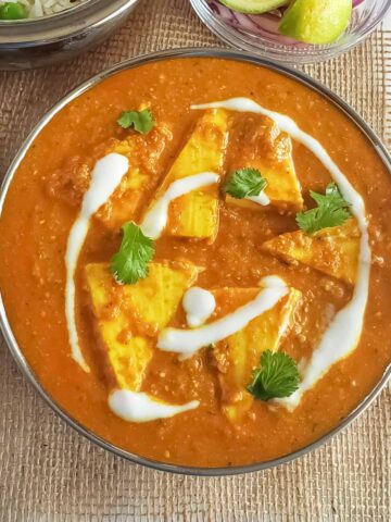 Shahi Paneer which is Indian cottage cheese curry recipe served in ethnic copper bowl.