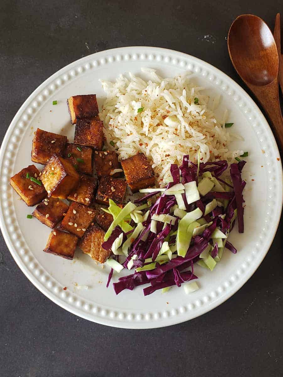 Crispy air fried tofu served with seasoned rice and coleslaw.