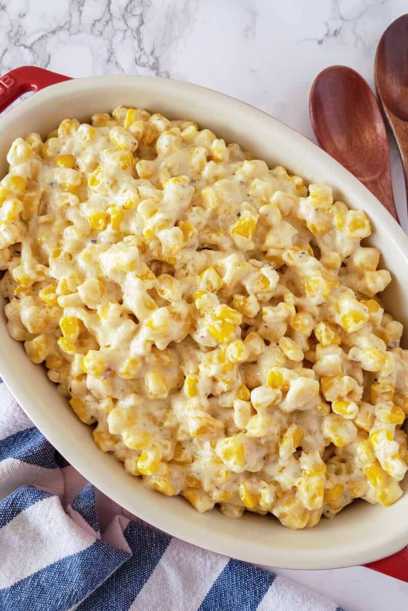 A dinner serving with sweet corn in creamy sauce as a side dish.