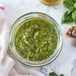 Basil walnut pesto sauce in a glass jar.