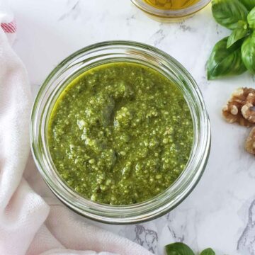 Basil walnut pesto sauce in a glass jar.