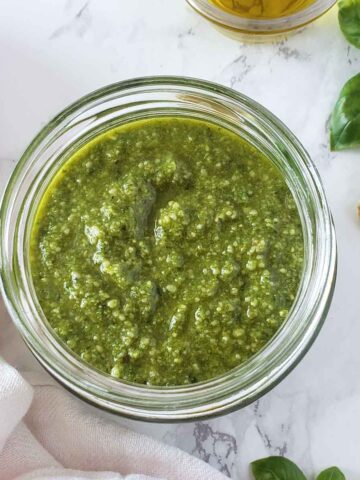 Basil walnut pesto sauce in a glass jar.