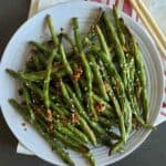 Air Fryer green beans with spicy Asian Marinade served on the plate.