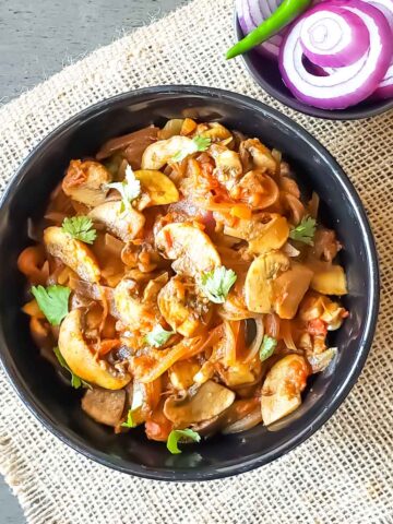 Mushroom masala recipe which is spicy Indian mushroom curry, in a serving bowl.
