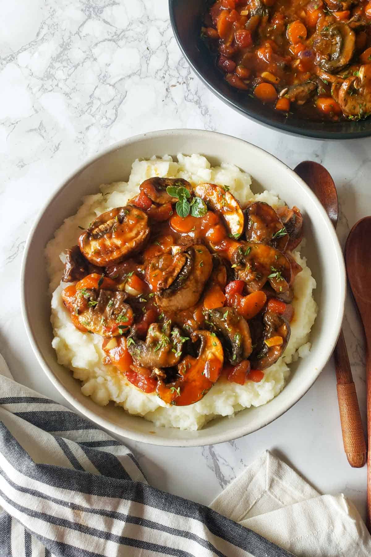 Rich and savory Mushroom stew with vegetables served over mashed potatoes.