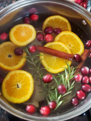 Christmas Potpourri simmer pot full of water, oranges, cranberries. rosemary and spices.