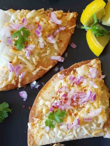 Pav Bhaji Quesadillas made by adding Indian street food pav bhaji in cheese quesadillas , served with chopped cilantro, onion and lemon wedges.