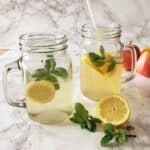 Apple cider vinegar and lemon juice drink served in a glass mason jars.