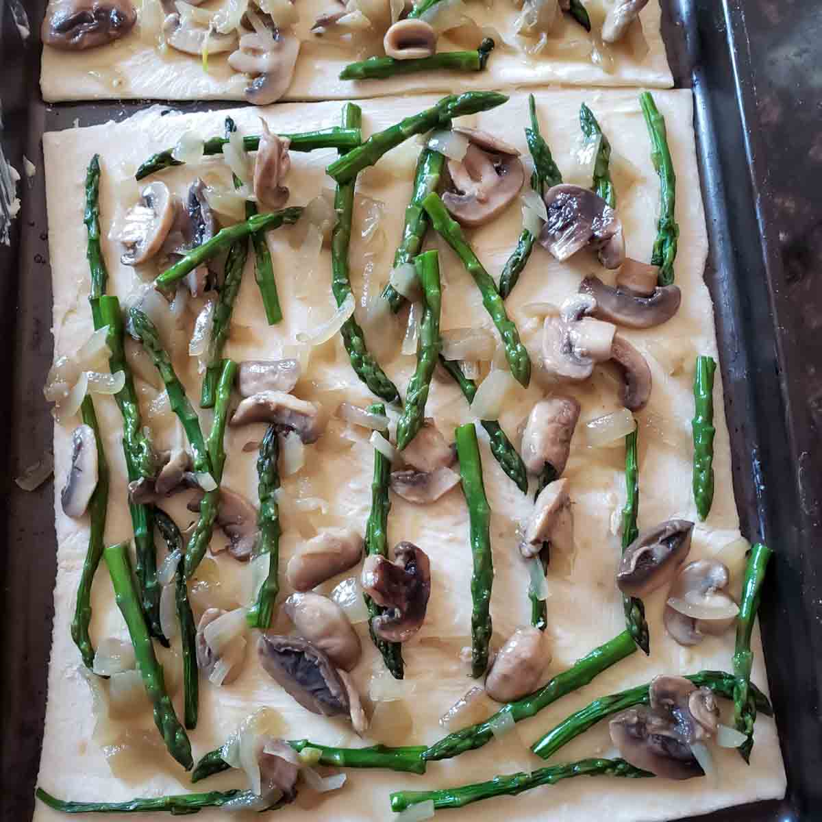 Process step five in making Asparagus Mushroom and Cheese Tart with Puff Pastry.
