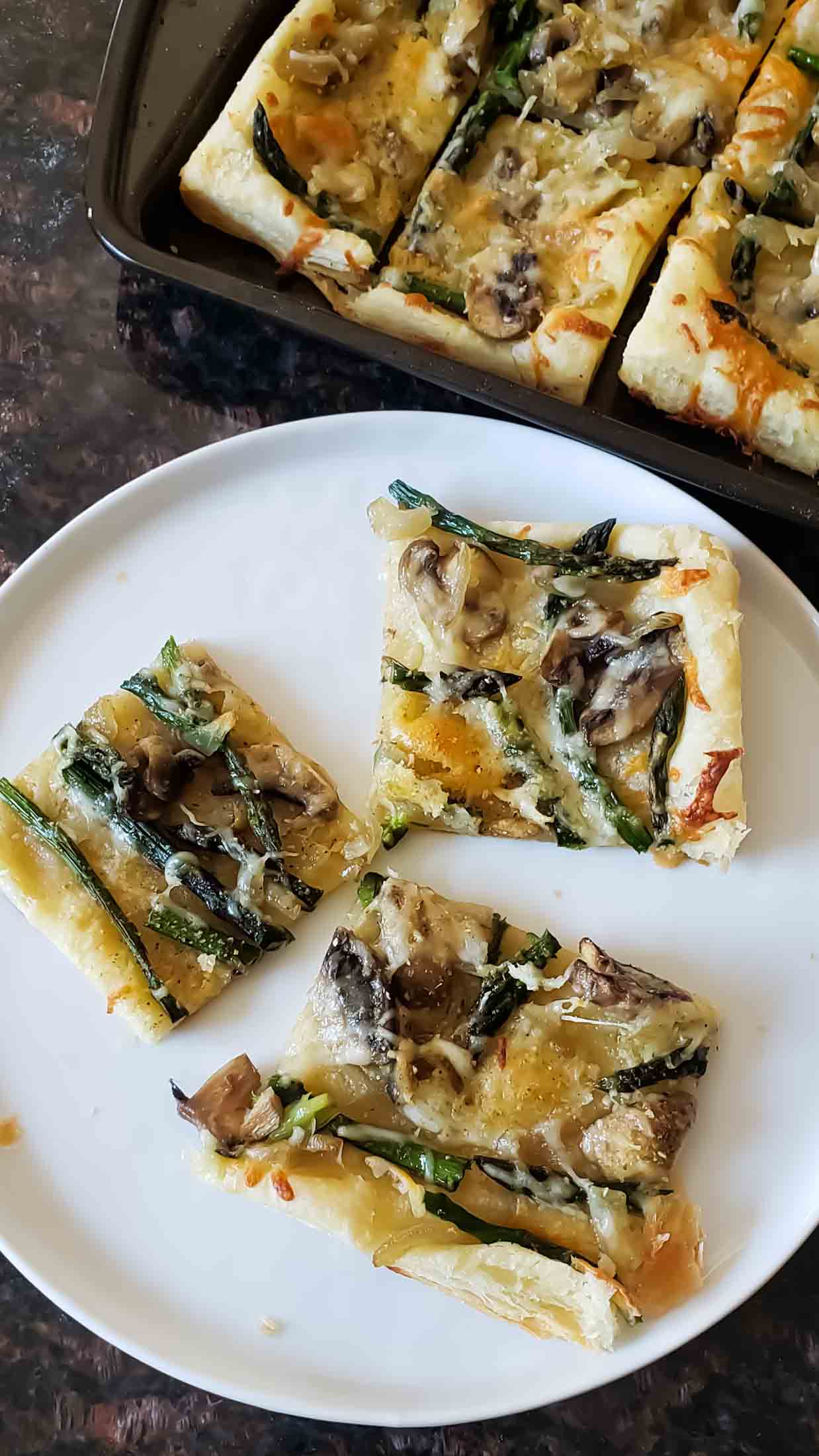 Asparagus and Cheese Puff Pastry Tart with golden brown crust served on the dish.