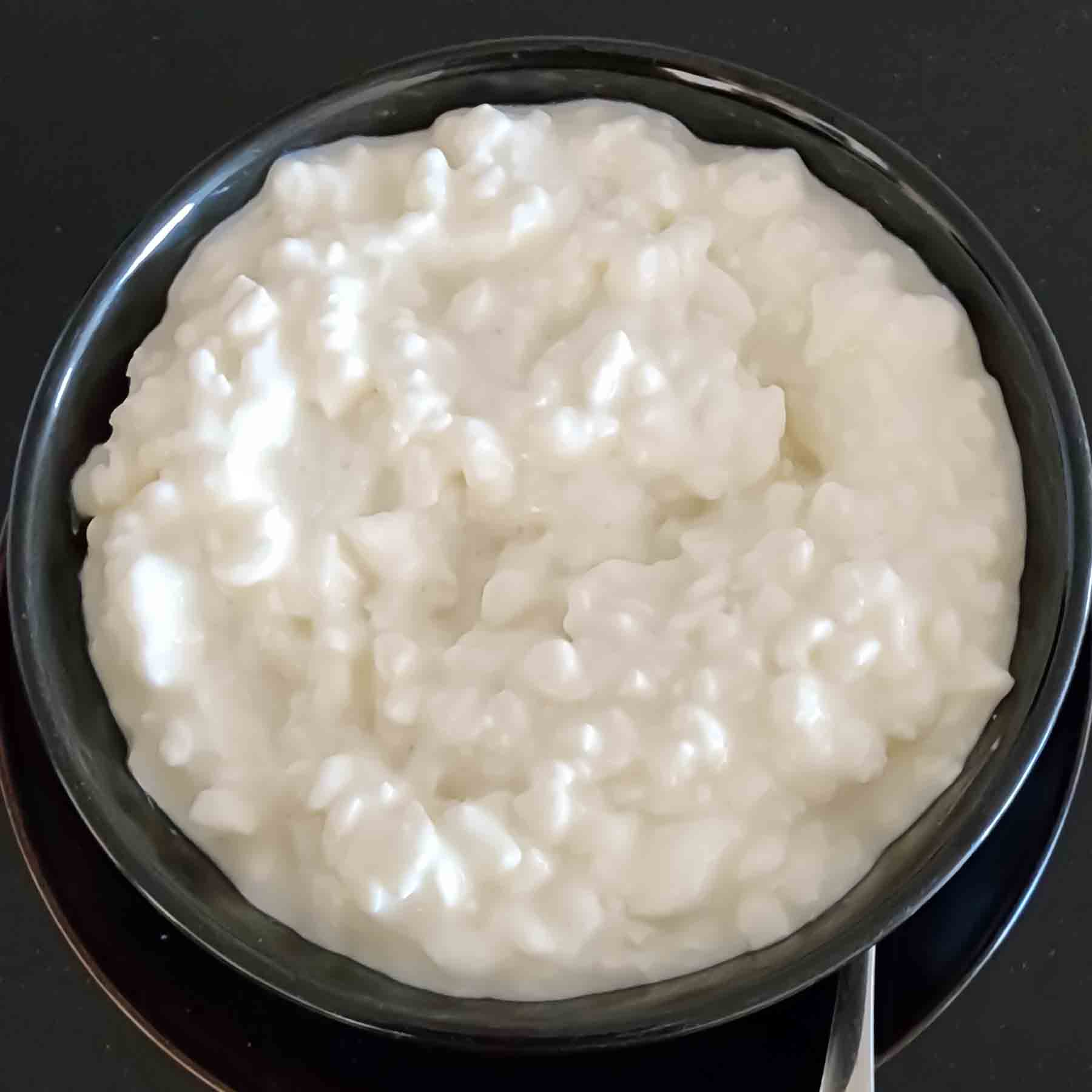 Creamy curdled cottage cheese in a bowl for healthy snacking.