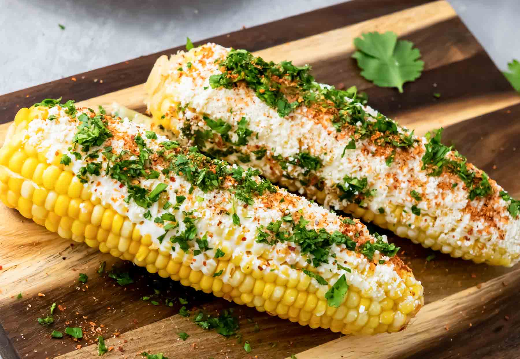 2 pieces of corn on the cob seasoned as street corn salad.