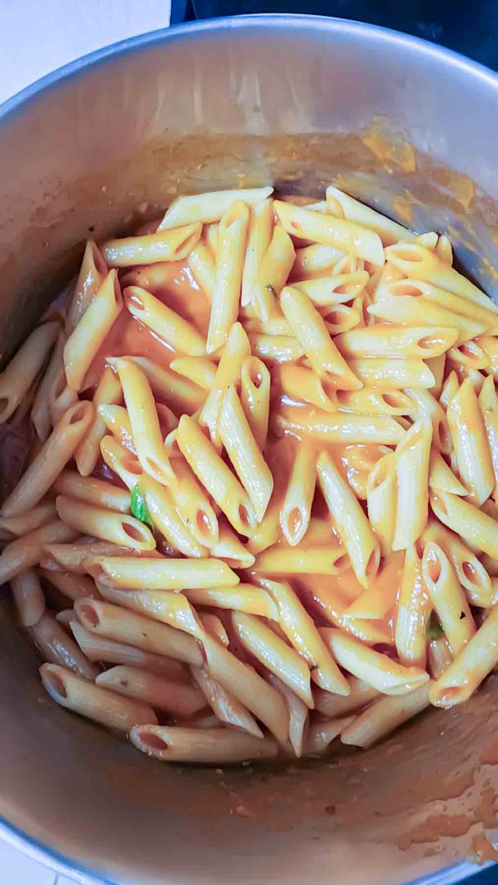 Combining pasta and the sauce for scrumptious dinner.