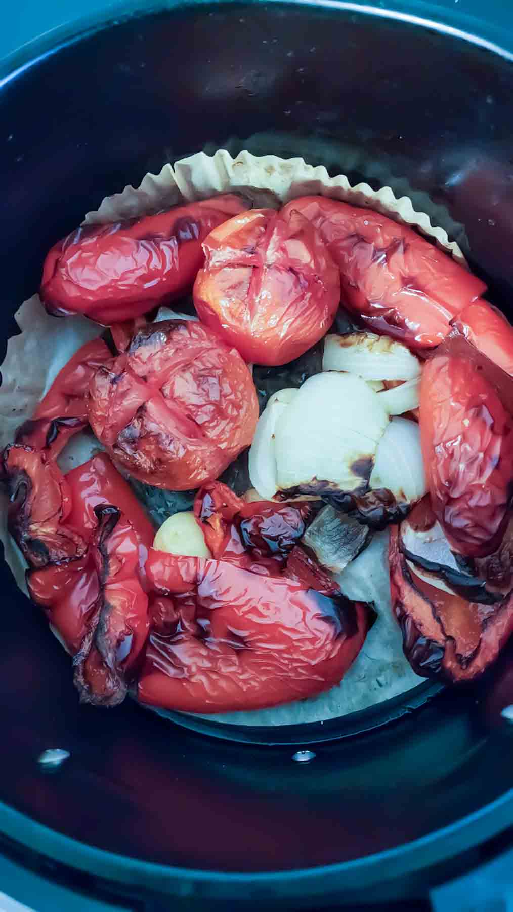 Roasting sweet red peppers, onion, tomatoes and garlic in the air fryer.