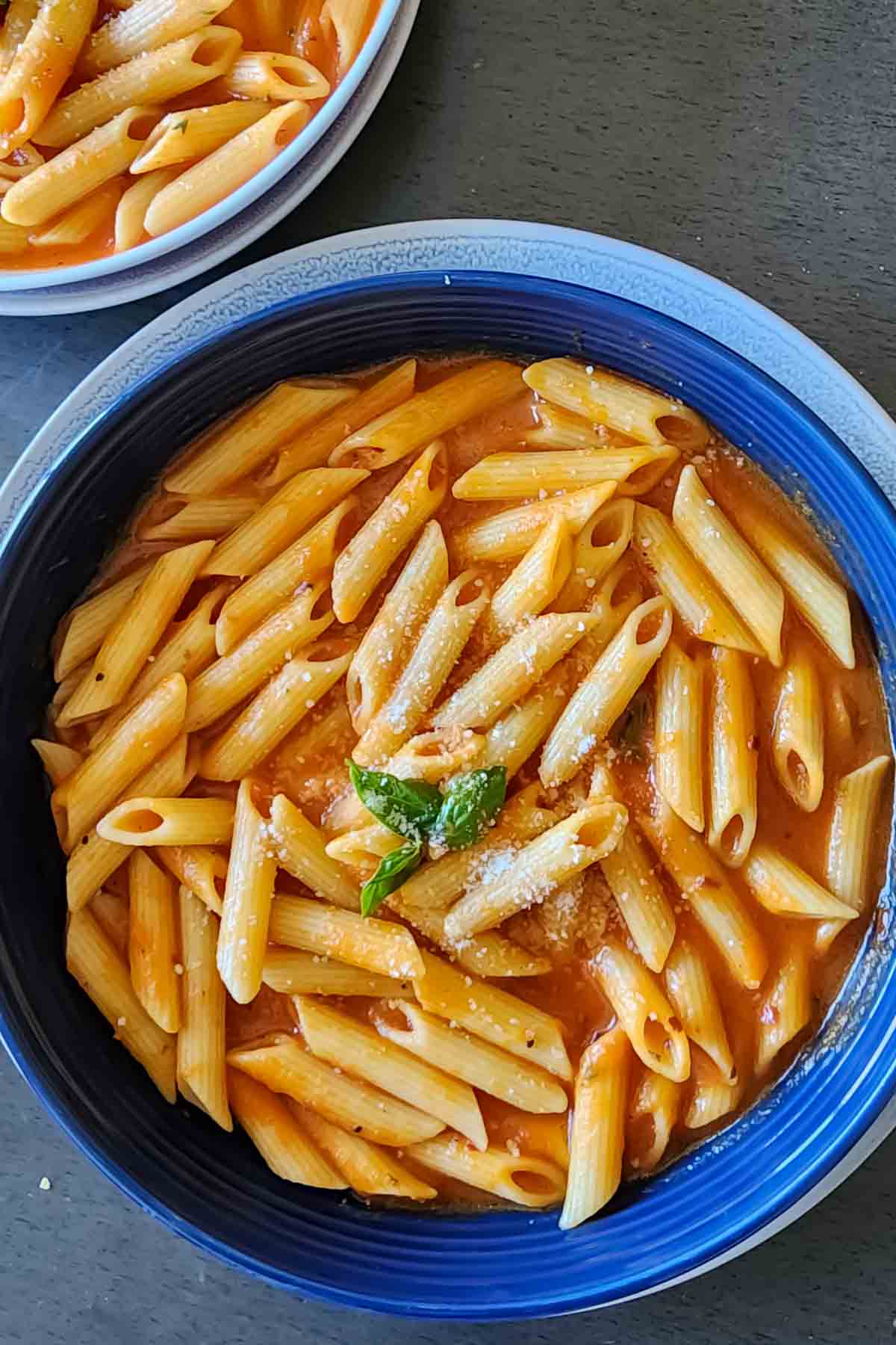 Penne Pasta with Roasted red pepper sauce served in a bowl.