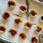 Cranberry Brie Phyllo Cups served with rosemary sprigs for an easy and elegant holiday party appetizer.