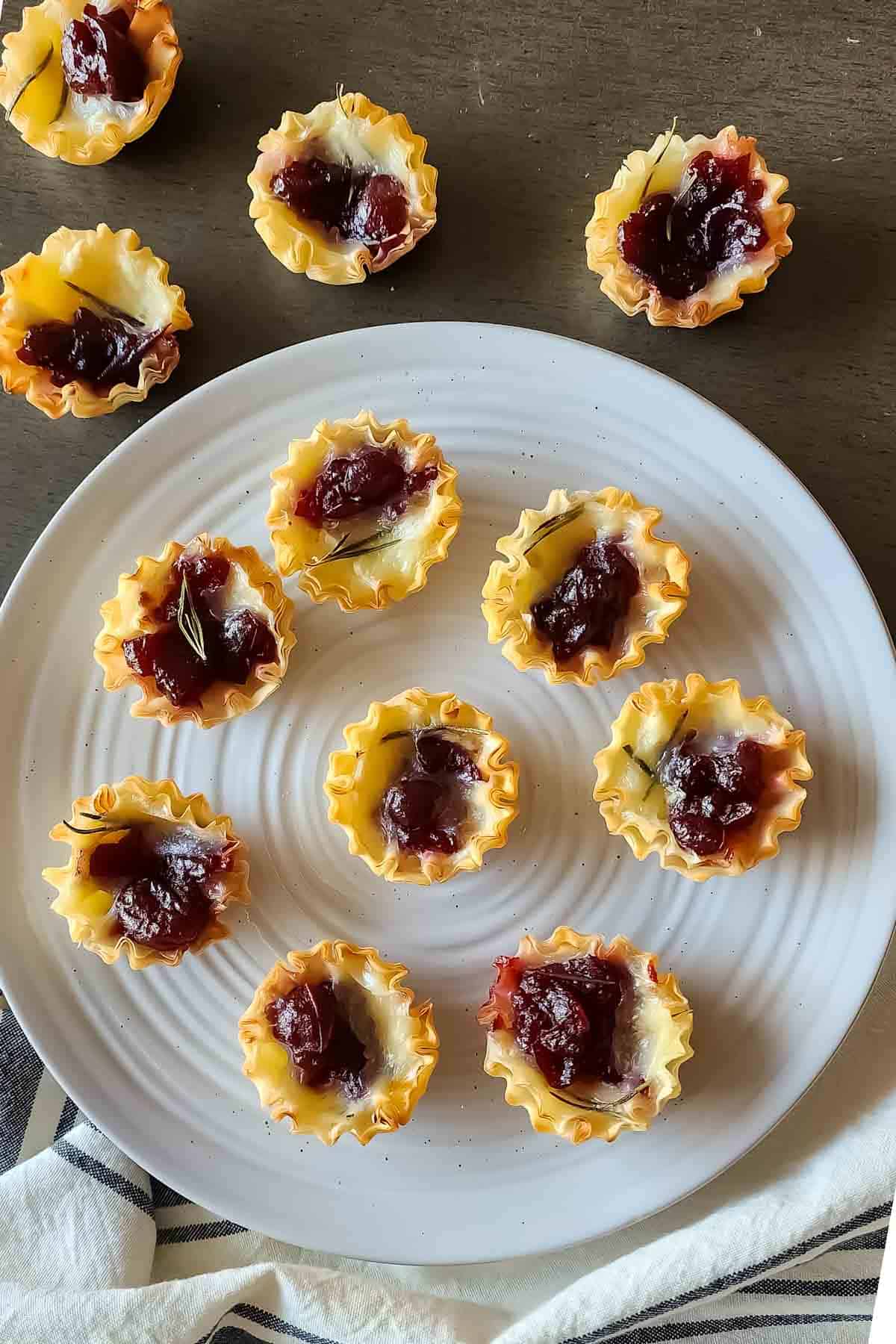 A serving Tray full of cranberry brie phyllo cup appetizer for party serving. 