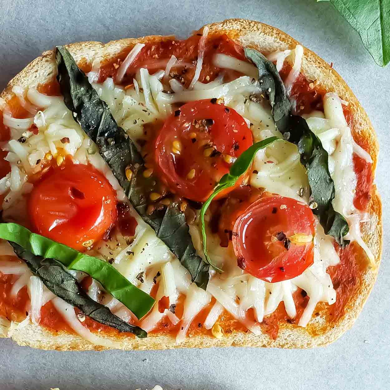 An easy pizza bread toast with toppings baked at home.