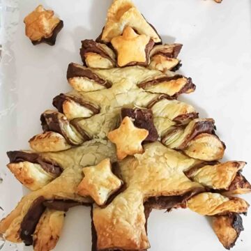 Nutella Puff Pastry Christmas tree with golden brown flaky crust and earthy rich filling served as a holiday dessert.