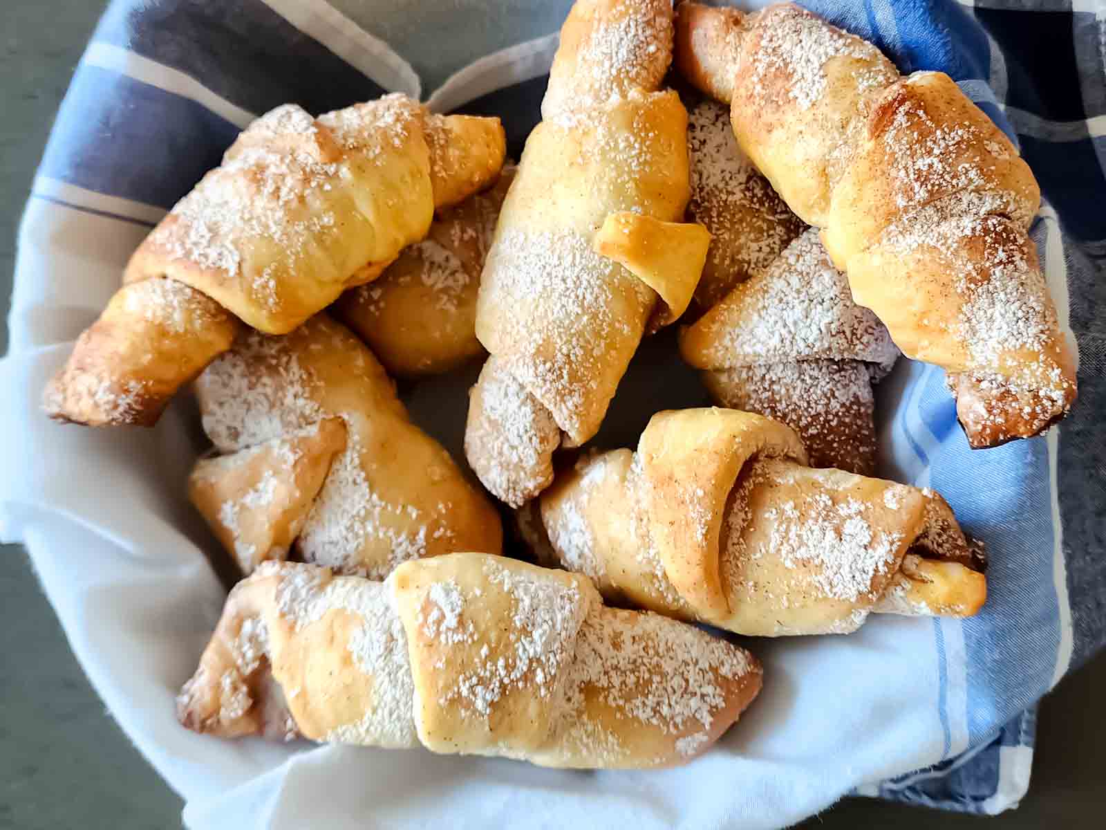 A bowl filled with homemade Cinnamon sugar crescent rolls.