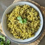 A serving bowl filled with spinach rice recipe.