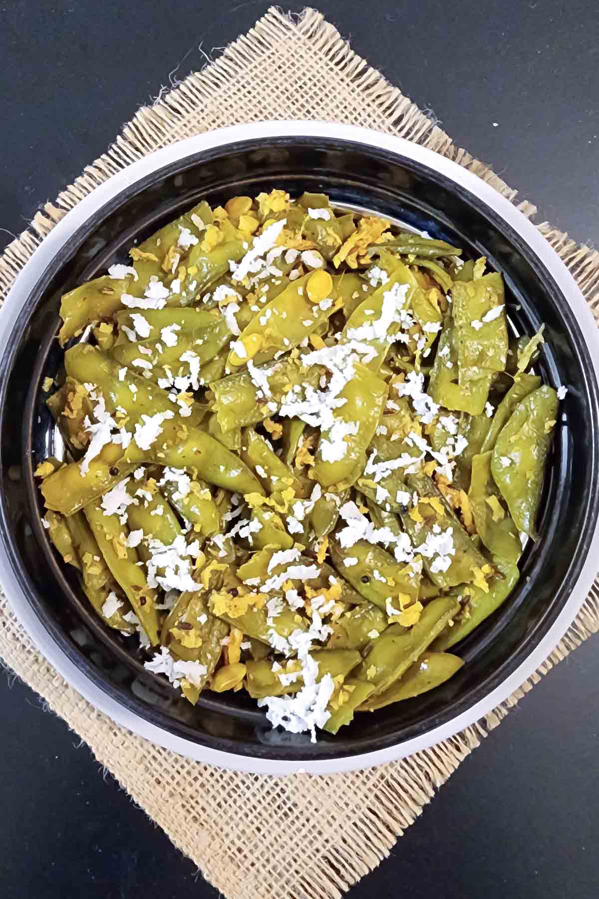 Delicious Goan Style Flat Beans Dry Sabzi with coconut served in a bowl.