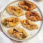 A serving plate with bakery style spicy Paneer Puff Pastry Appetizer made in oven or air fryer and served for party appetizer.