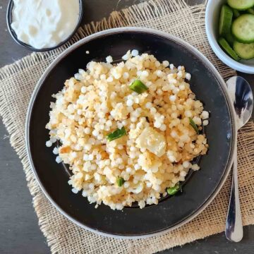 Sabudana khichdi which is popular Indian tapioca pearls pulao or pilaf is served with fresh garnishes.