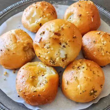 Buttery pizza puffs with garnishes.