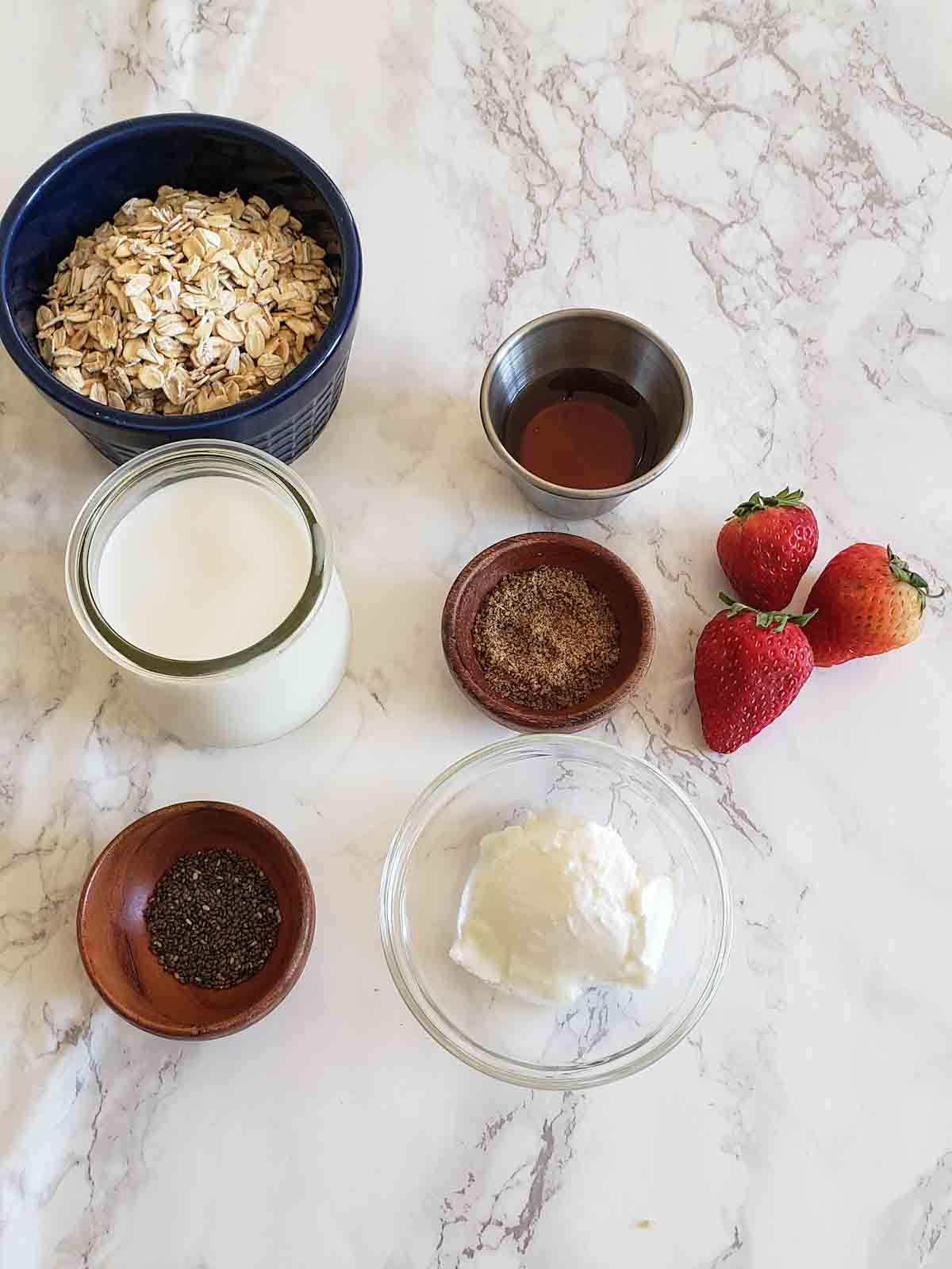 Seven basic ingredients used in making Strawberries and cream overnight oats recipe.
