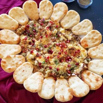 Indian 7-layer dip which is fusion Indo-Mexican recipe for Indian Chaat Board is presented as a party appetizer.