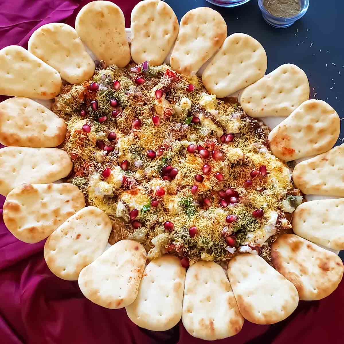 Indian 7-layer dip which is fusion Indo-Mexican recipe for Indian Chaat Board is presented as a party appetizer.
