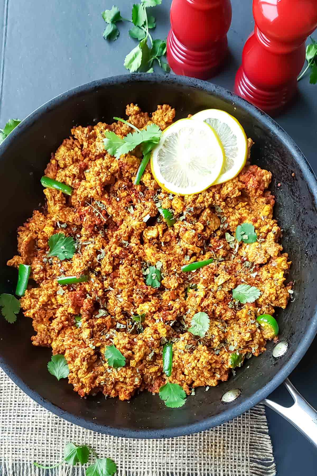 A skillet full of spiced cottage cheese scramble which is Paneer Bhurji.